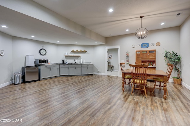 6133 Ridgeview Ct, Joplin, MO 64804 - dining room featuring recessed lighting, light wood-style flooring, and a chandelier