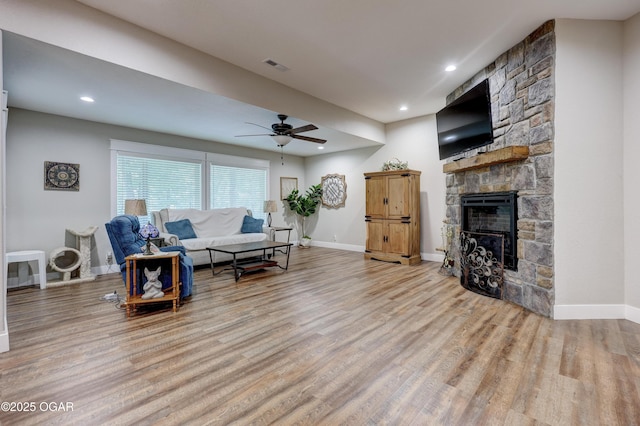 6133 Ridgeview Ct, Joplin, MO 64804 - living room with wood finished floors, a fireplace, ceiling fan, and recessed lighting