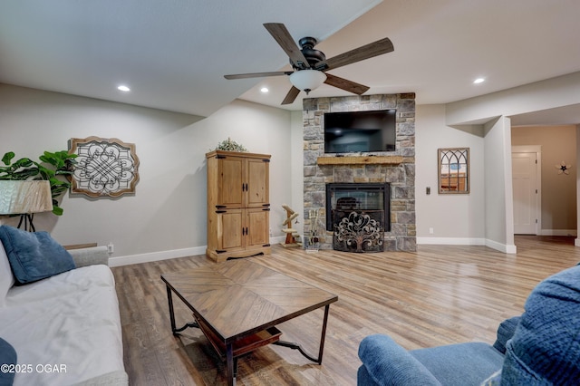 6133 Ridgeview Ct, Joplin, MO 64804 - living area with ceiling fan, wood finished floors, a stone fireplace, and recessed lighting