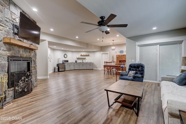 6133 Ridgeview Ct, Joplin, MO 64804 - living area with a ceiling fan, wood finished floors, a fireplace, and recessed lighting