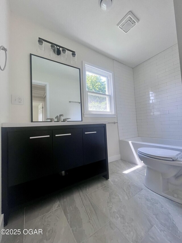 828 S Porter Ave, Joplin, MO 64801 - full bathroom featuring vanity, marble look tiles, and a bathtub