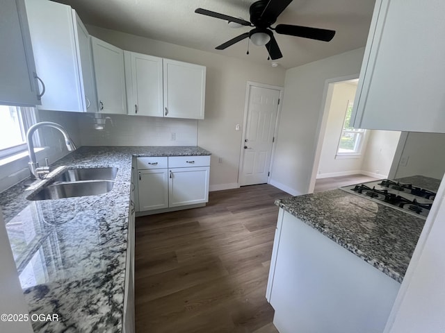 828 S Porter Ave, Joplin, MO 64801 - kitchen featuring stovetop, white cabinets, stone counters, dark wood-type flooring, and a ceiling fan