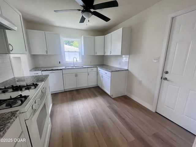828 S Porter Ave, Joplin, MO 64801 - kitchen with white appliances, a ceiling fan, ventilation hood, wood finished floors, and light stone counters