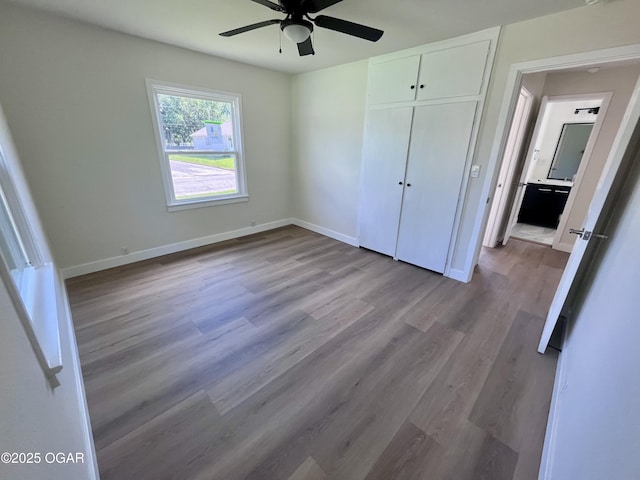 828 S Porter Ave, Joplin, MO 64801 - unfurnished bedroom with wood finished floors, a closet, and ceiling fan