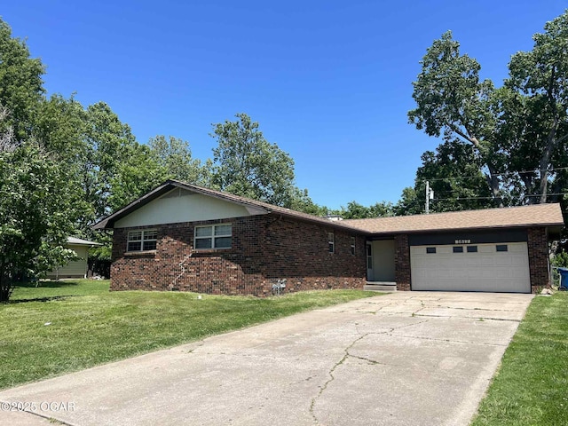 1617 Massachusetts Ave, Joplin, MO 64804 - single story home featuring brick siding, a garage, driveway, and a front lawn