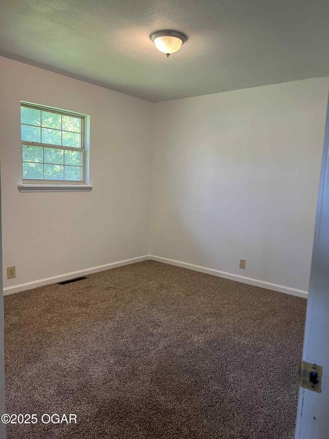1617 Massachusetts Ave, Joplin, MO 64804 - carpeted spare room with a textured ceiling