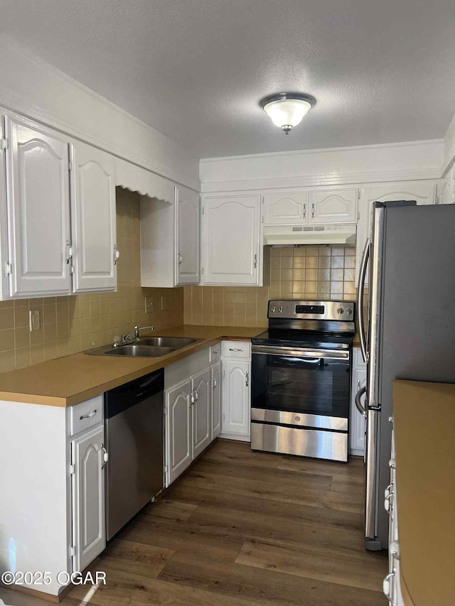1617 Massachusetts Ave, Joplin, MO 64804 - kitchen featuring stainless steel appliances, under cabinet range hood, white cabinetry, and dark wood-type flooring