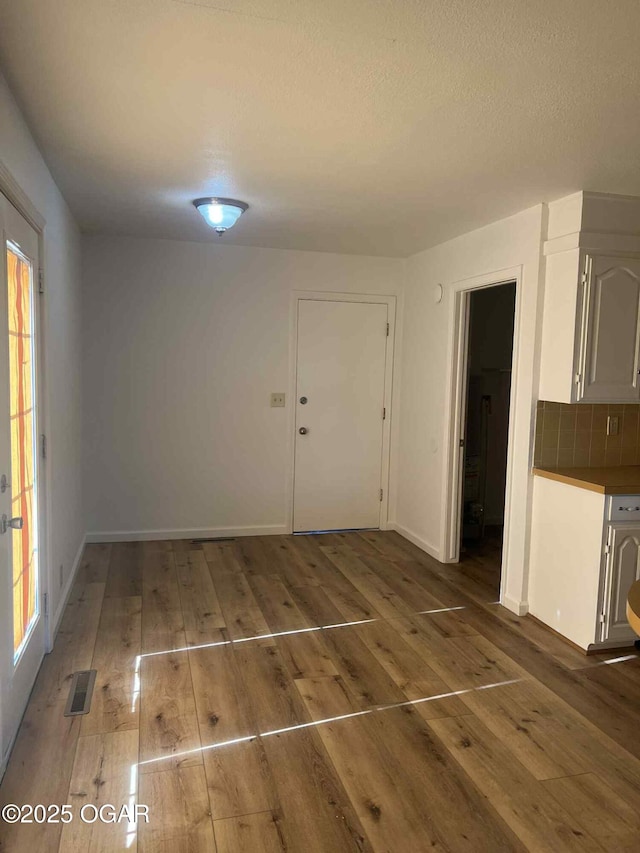 1617 Massachusetts Ave, Joplin, MO 64804 - unfurnished dining area featuring wood finished floors and baseboards