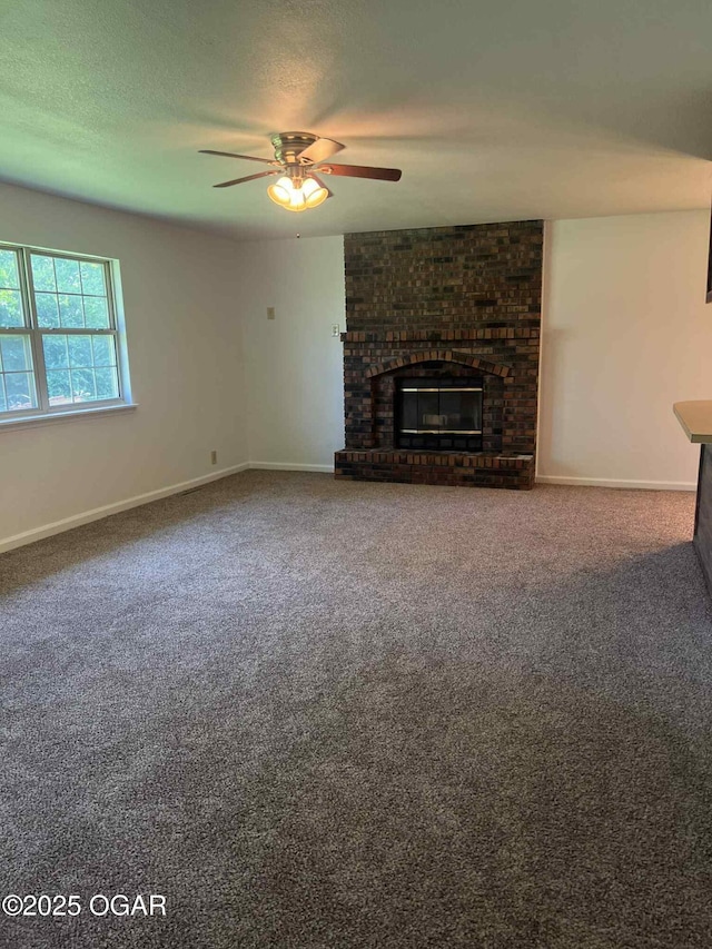 1617 Massachusetts Ave, Joplin, MO 64804 - unfurnished living room featuring a ceiling fan, carpet, and a fireplace