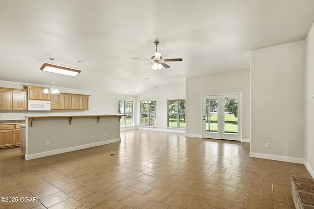 305 Dogwood Trails Loop, Carl Junction, MO 64834 - unfurnished living room with ceiling fan, lofted ceiling, a chandelier, and tile patterned flooring
