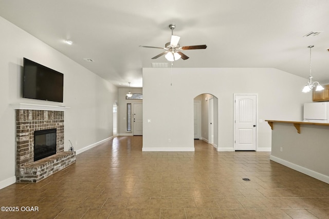 305 Dogwood Trails Loop, Carl Junction, MO 64834 - unfurnished living room featuring ceiling fan, arched walkways, a fireplace, vaulted ceiling, and a chandelier