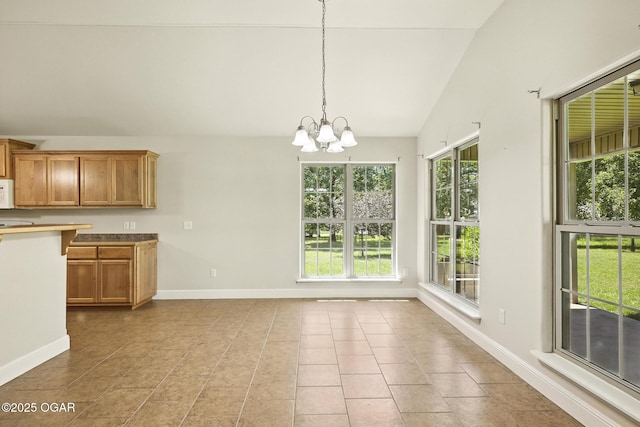 305 Dogwood Trails Loop, Carl Junction, MO 64834 - kitchen featuring vaulted ceiling, a chandelier, brown cabinets, tile patterned floors, and hanging light fixtures