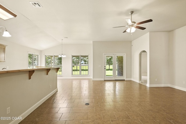 305 Dogwood Trails Loop, Carl Junction, MO 64834 - unfurnished living room featuring healthy amount of natural light, a ceiling fan, lofted ceiling, a chandelier, and arched walkways