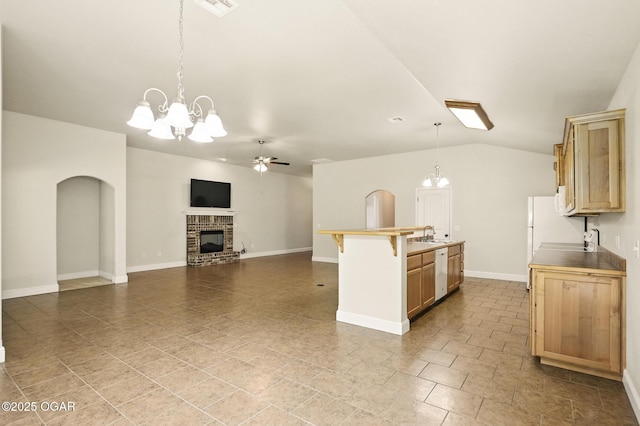 305 Dogwood Trails Loop, Carl Junction, MO 64834 - kitchen featuring white appliances, ceiling fan, arched walkways, a fireplace, and a center island with sink