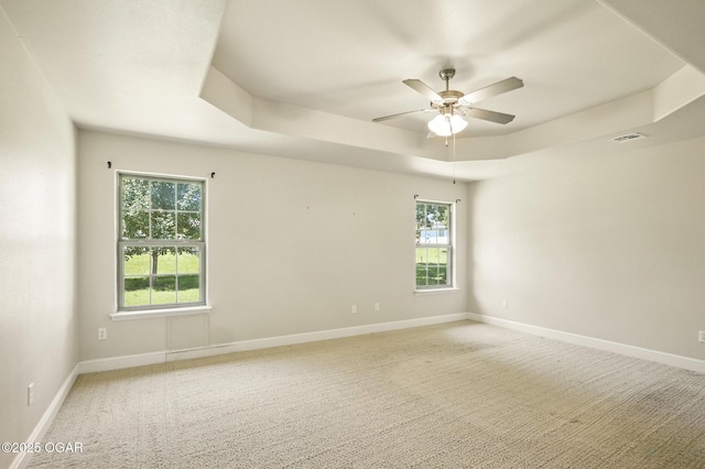 305 Dogwood Trails Loop, Carl Junction, MO 64834 - spare room featuring a tray ceiling, a ceiling fan, and light colored carpet