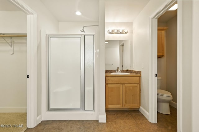 305 Dogwood Trails Loop, Carl Junction, MO 64834 - bathroom with a stall shower, vanity, a walk in closet, and tile patterned floors