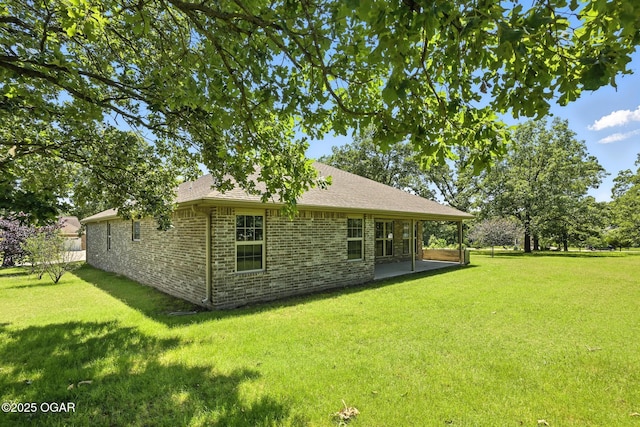 305 Dogwood Trails Loop, Carl Junction, MO 64834 - back of house with brick siding, a lawn, a patio area, and a shingled roof