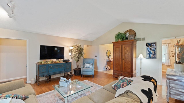 21974 S 1825th Rd, Milo, MO 64767 - living room featuring vaulted ceiling and wood finished floors