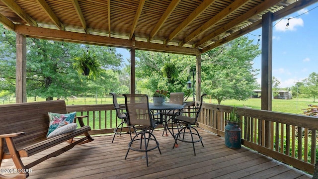 21974 S 1825th Rd, Milo, MO 64767 - wooden terrace featuring outdoor dining space, a lawn, and view of scattered trees
