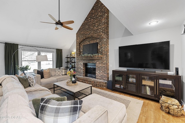 3502 Hackberry Ln, Joplin, MO 64801 - living area featuring wood finished floors, ceiling fan, a brick fireplace, and high vaulted ceiling