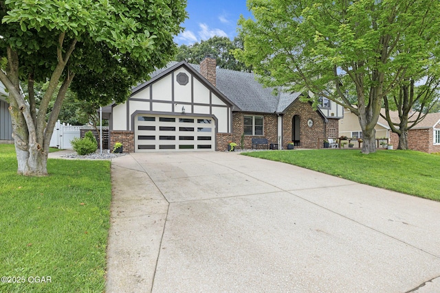 3502 Hackberry Ln, Joplin, MO 64801 - tudor-style house with brick siding, a garage, a chimney, and concrete driveway