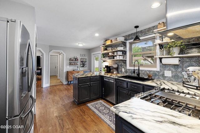 3502 Hackberry Ln, Joplin, MO 64801 - kitchen featuring stainless steel fridge, dishwashing machine, open shelves, arched walkways, and wood finished floors