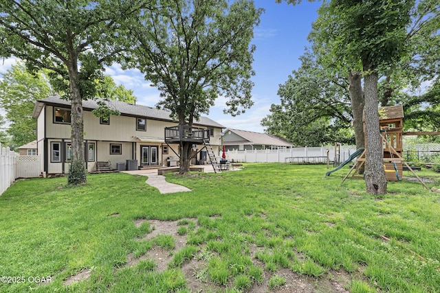 3502 Hackberry Ln, Joplin, MO 64801 - back of house featuring a fenced backyard, a playground, a wooden deck, and a patio