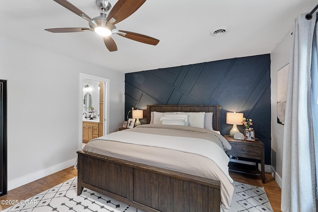 3502 Hackberry Ln, Joplin, MO 64801 - bedroom with an accent wall, light wood-type flooring, ceiling fan, and connected bathroom