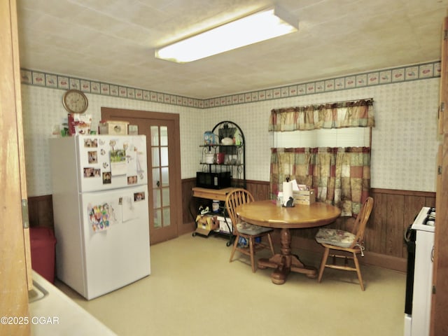 722 E Budlong St, Carthage, MO 64836 - carpeted dining space featuring a wainscoted wall, wallpapered walls, and wooden walls