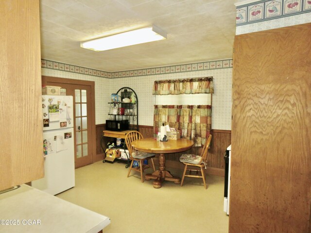 722 E Budlong St, Carthage, MO 64836 - carpeted dining space with a wainscoted wall and wooden walls