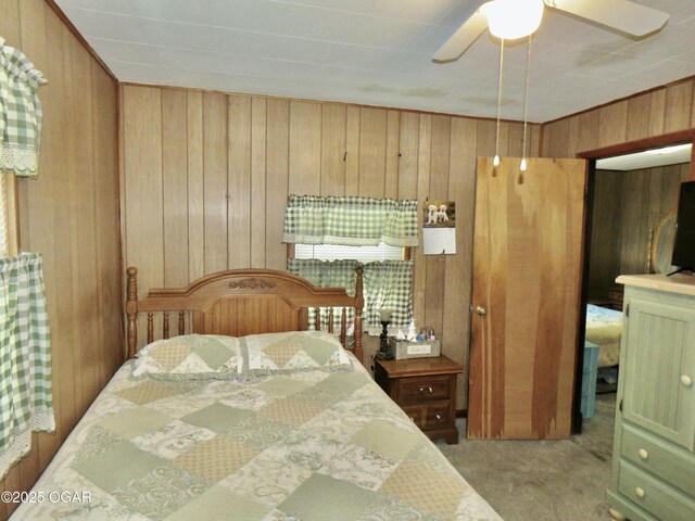 722 E Budlong St, Carthage, MO 64836 - carpeted bedroom with wooden walls and a ceiling fan