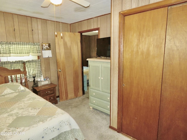 722 E Budlong St, Carthage, MO 64836 - bedroom featuring wooden walls, light carpet, a ceiling fan, and a closet