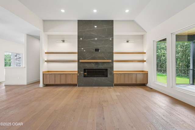 5077 Eagle Valley Dr, Joplin, MO 64804 - unfurnished living room featuring light wood-style floors, a premium fireplace, recessed lighting, and lofted ceiling