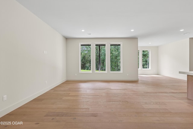 5077 Eagle Valley Dr, Joplin, MO 64804 - empty room featuring healthy amount of natural light, light wood finished floors, and recessed lighting