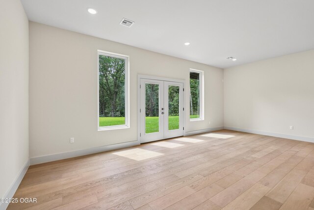 5077 Eagle Valley Dr, Joplin, MO 64804 - empty room featuring healthy amount of natural light, french doors, light wood-type flooring, and recessed lighting