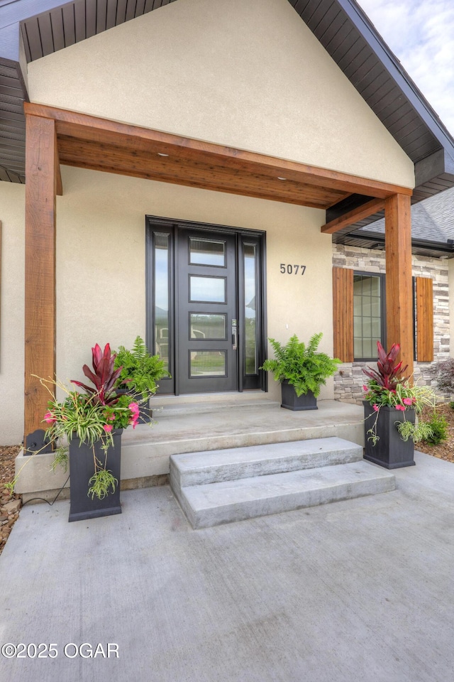 5077 Eagle Valley Dr, Joplin, MO 64804 - doorway to property featuring stucco siding and a porch