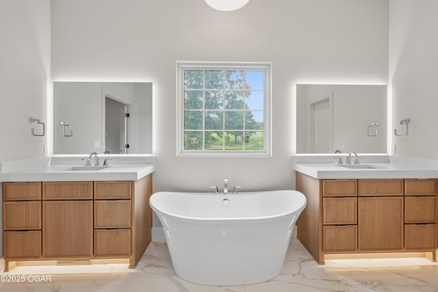 5077 Eagle Valley Dr, Joplin, MO 64804 - bathroom featuring marble look tile flooring, two vanities, and a freestanding bath
