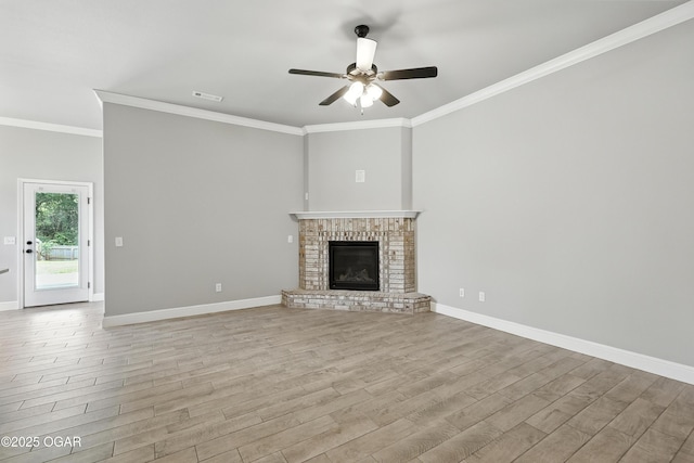 2102 S Greystone Sq, Oronogo, MO 64855 - unfurnished living room with light wood-type flooring, ceiling fan, crown molding, and a fireplace