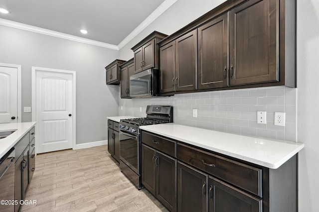 2102 S Greystone Sq, Oronogo, MO 64855 - kitchen with appliances with stainless steel finishes, ornamental molding, dark brown cabinets, light wood-type flooring, and backsplash
