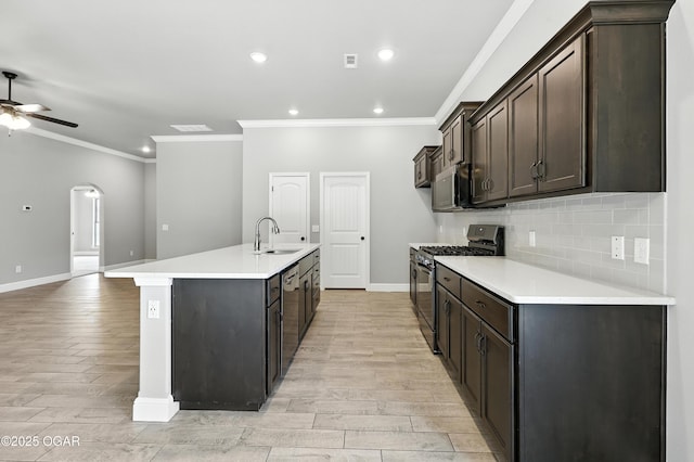 2102 S Greystone Sq, Oronogo, MO 64855 - kitchen featuring appliances with stainless steel finishes, light wood-style floors, crown molding, ceiling fan, and backsplash