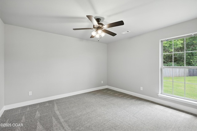 2102 S Greystone Sq, Oronogo, MO 64855 - spare room featuring dark colored carpet, a ceiling fan, and plenty of natural light