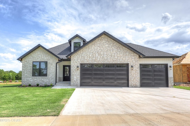 4308 Par Ln, Joplin, MO 64804 - french provincial home featuring stone siding, an attached garage, concrete driveway, a front yard, and roof with shingles