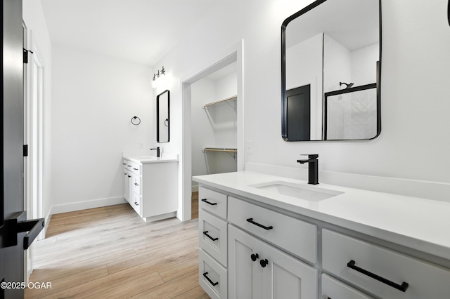 4308 Par Ln, Joplin, MO 64804 - full bath with two vanities, wood finished floors, and a shower