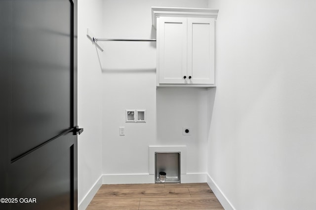 4308 Par Ln, Joplin, MO 64804 - laundry area with hookup for an electric dryer, washer hookup, light wood finished floors, and cabinet space