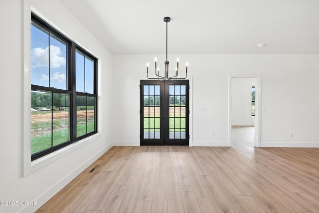 4308 Par Ln, Joplin, MO 64804 - unfurnished dining area featuring a chandelier, light wood finished floors, healthy amount of natural light, and french doors
