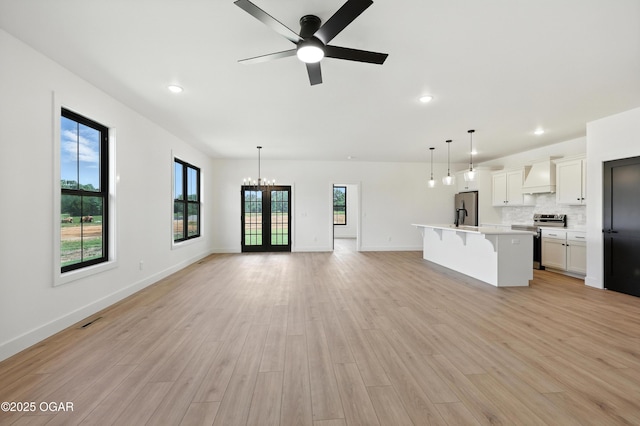 4308 Par Ln, Joplin, MO 64804 - unfurnished living room featuring a chandelier, light wood-type flooring, ceiling fan, and recessed lighting