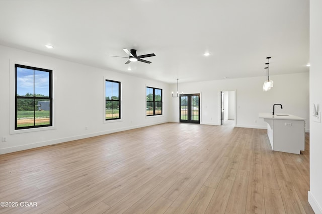 4308 Par Ln, Joplin, MO 64804 - unfurnished living room featuring a ceiling fan, light wood finished floors, recessed lighting, and a chandelier