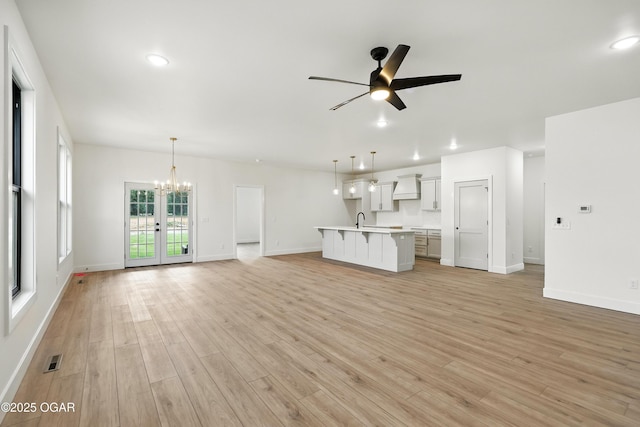4402 Par Ln, Joplin, MO 64804 - unfurnished living room featuring ceiling fan, a chandelier, light wood-style floors, and recessed lighting