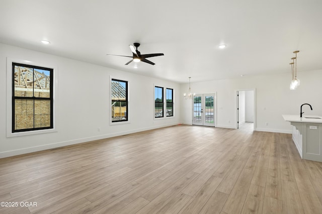 4402 Par Ln, Joplin, MO 64804 - unfurnished living room with ceiling fan, a chandelier, light wood-type flooring, and recessed lighting