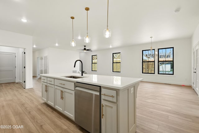 4402 Par Ln, Joplin, MO 64804 - kitchen with stainless steel dishwasher, light wood-style flooring, light countertops, a center island with sink, and recessed lighting